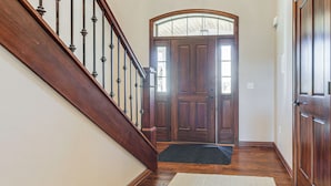 A wooden staircase leading to a door with a glass panel. - 8 Mi to Lambeau Field: Family Home in De Pere! (De Pere)