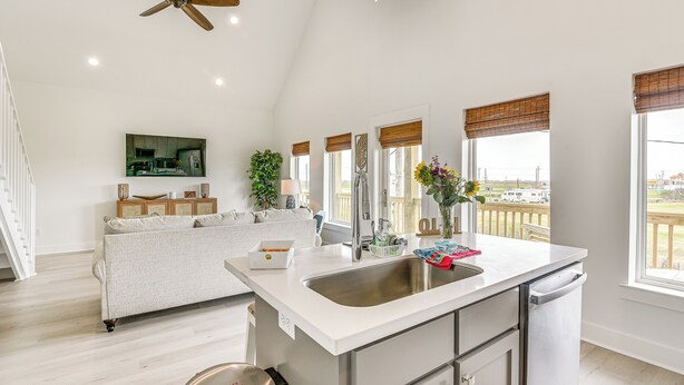 A modern kitchen with a large island, stainless steel appliances, and a view of the outdoors. - Walk to Crystal Beach: 'the Sandbar Escape' (Port Bolivar)