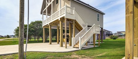 A two-story house with a balcony and a staircase leading to the upper floor.
