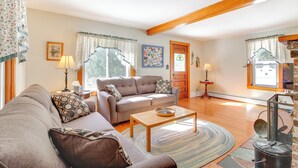 A living room with a sofa, coffee table, and a fireplace. - Swim, Ski & Sip: Lakefront Retreat in Plymouth (Plymouth)