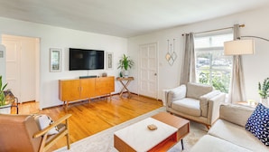 A modern living room with a flat-screen TV, wooden furniture, a sofa, and a coffee table. - 3 Mi to Universal Studios: Chic Home w/ Yard! (Burbank)