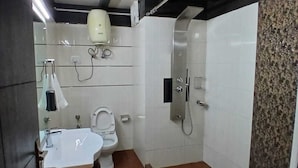 A compact bathroom with a toilet, sink, and shower. - Hotel Drive Inn Mussoorie (Mussoorie)