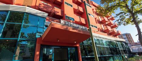 A modern building with a sign reading "H. Mediterraneo".