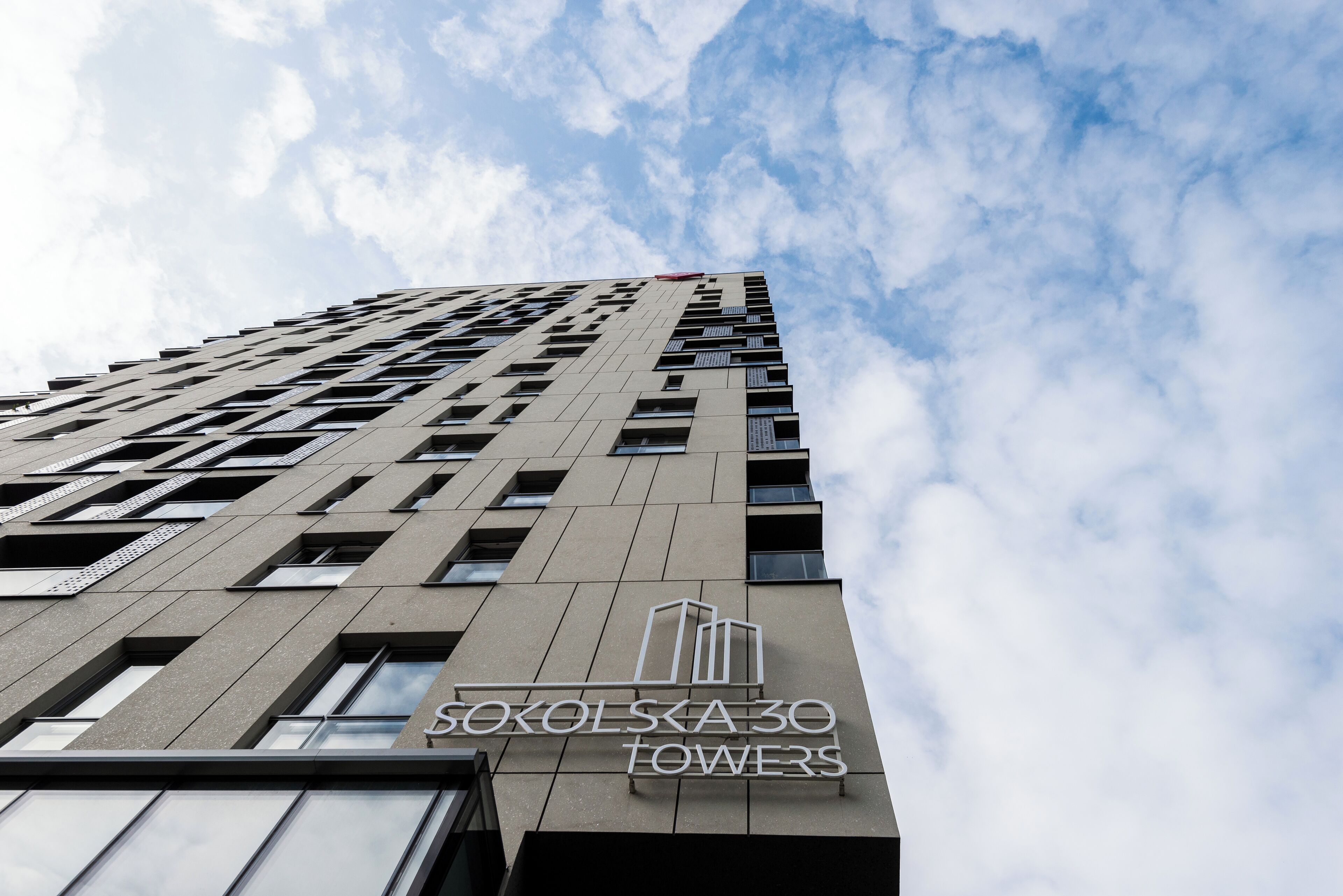 A tall building with a sign reading "SOKOLSKA 30 TOWERS".