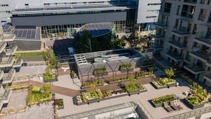 A rooftop garden with seating areas and solar panels. - Tower II by Kairos Apartments (Katowice)