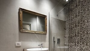 A modern bathroom with a wooden vanity, a large mirror, and a glass shower enclosure. - La Maison Coloniale Suites (The Saigon Jade) and Wellness Zone (Cagliari)