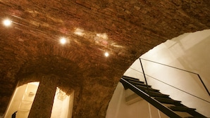 An interior with a brick ceiling, a staircase, and a white wall. - dHomes -Loft suite in Duomo (Milan)