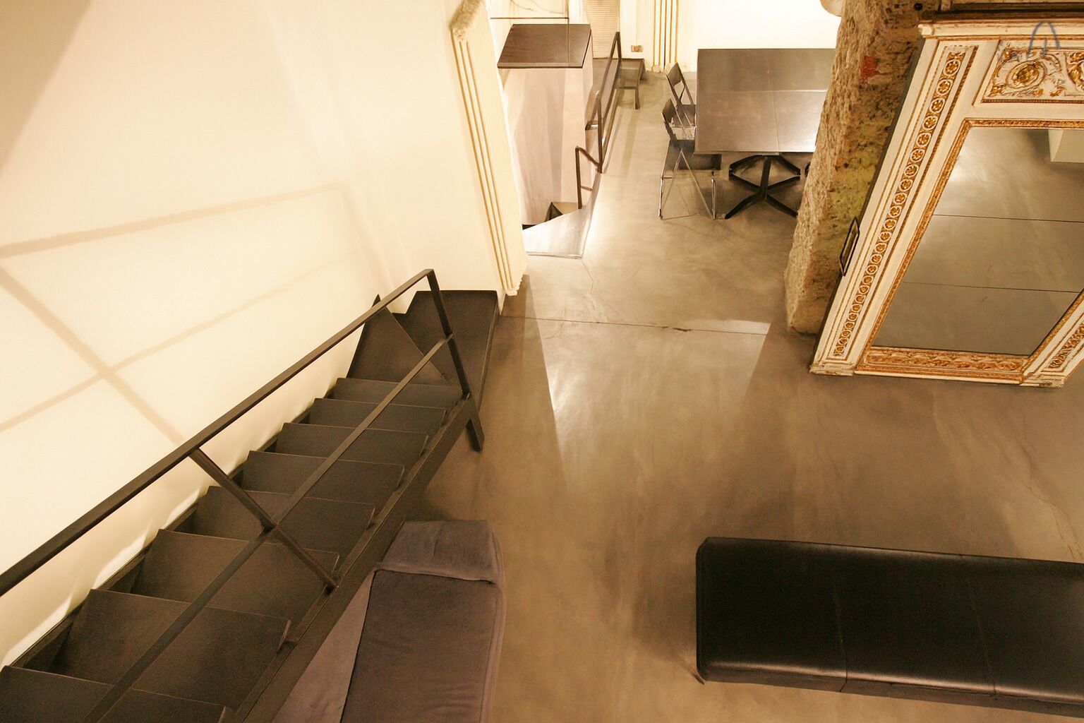 A staircase leading to a dining area with a table and chairs.