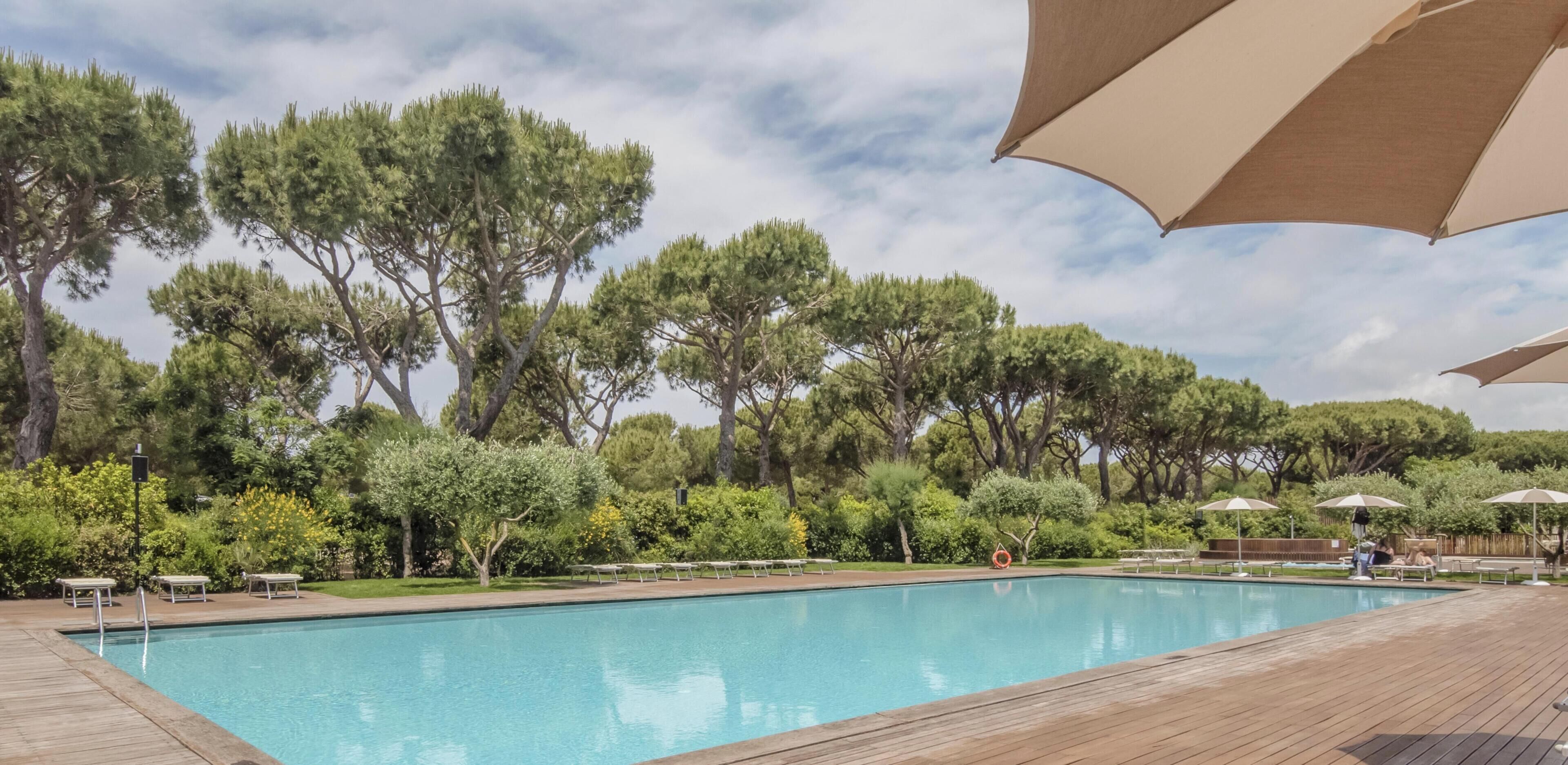 Seasonal outdoor pool, open 10:00 AM to 6:00 PM, pool umbrellas