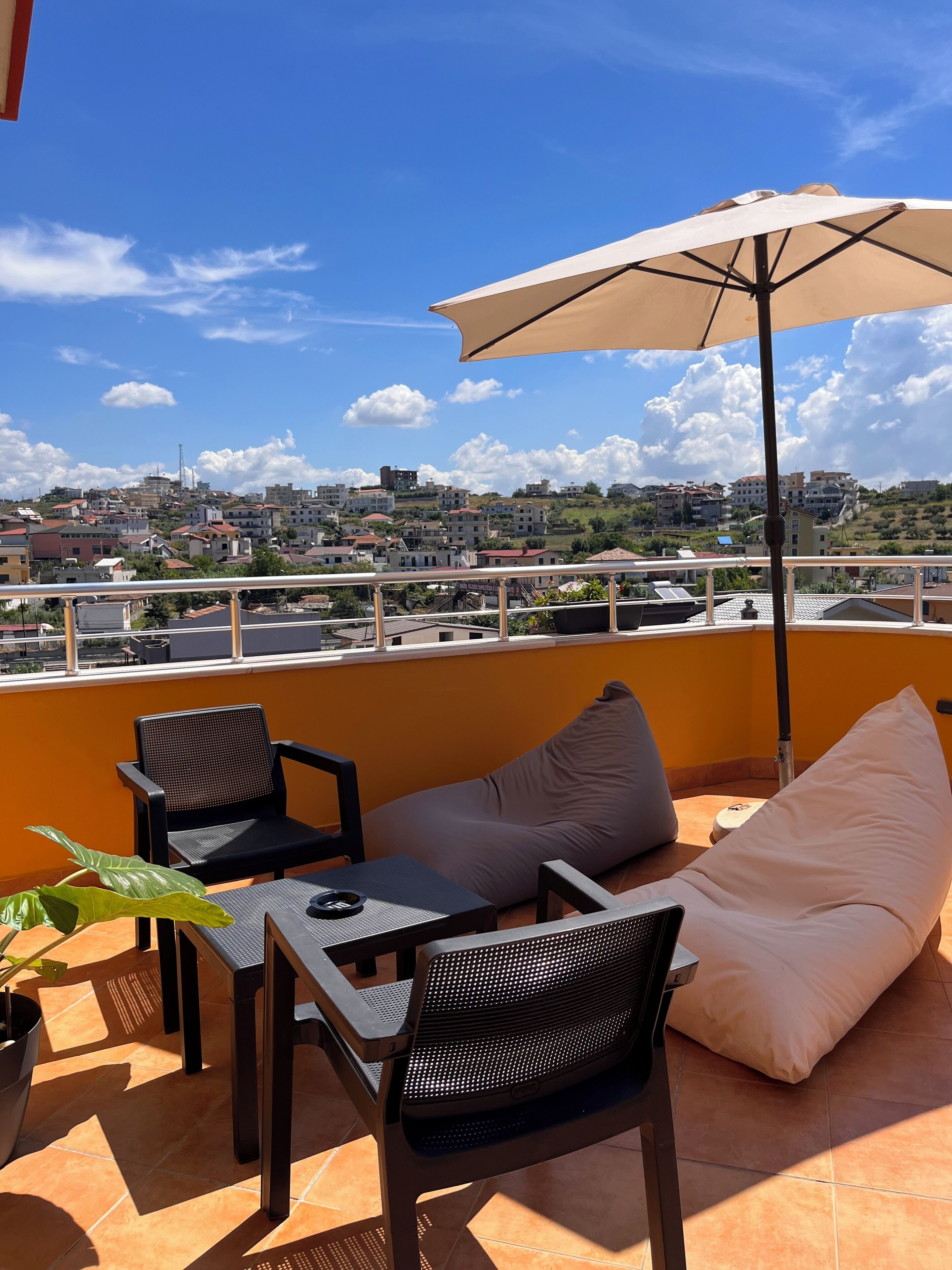 Une terrasse aménagée avec du mobilier d’extérieur, une table et un parasol.