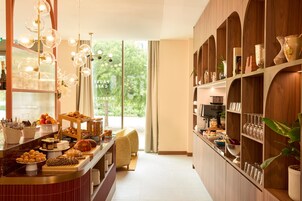 A breakfast buffet with various food items and a seating area.