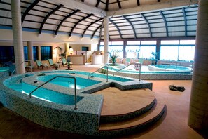 A large indoor swimming pool with multiple levels and a covered roof. - Amarestyle IGV Club Baia Samuele (Scicli)