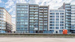 A modern high-rise building with multiple balconies and large windows. - Apartment in Middelkerke With Sea View (Middelkerke)
