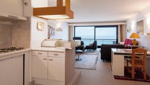 A modern hotel room with a kitchen, a dining area, and a living space. - Apartment in Middelkerke With Sea View (Middelkerke)
