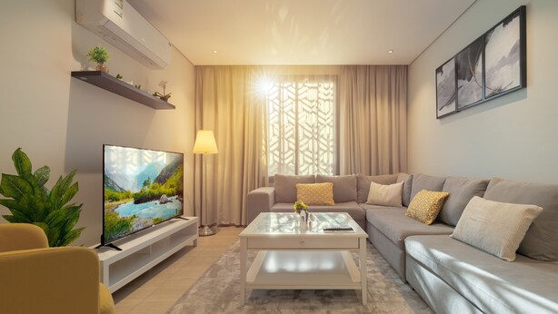 A modern living room with a flat-screen TV, a sofa, a coffee table, and a lamp. - Qurtoba big apartment all yours (Riyadh)