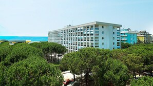 A multi-story hotel with a modern design, located near a coastline.