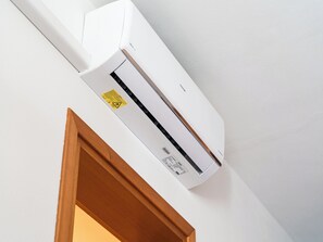 A white air conditioning unit mounted on a wall. - Cozy Apartment With Sunny Terrace in Bibione (San Michele al Tagliamento)