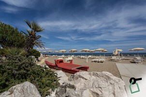 Private beach, white sand, sun loungers, beach umbrellas