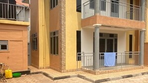A two-story residential building with a balcony on the upper floor. - CHALWE HOTEL APART (Kigali)