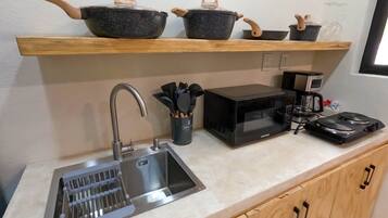 Fridge, microwave, coffee/tea maker, cookware/dishes/utensils