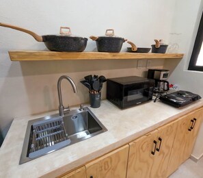 Fridge, microwave, coffee/tea maker, cookware/dishes/utensils