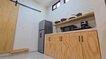 Fridge, microwave, coffee/tea maker, cookware/dishes/utensils