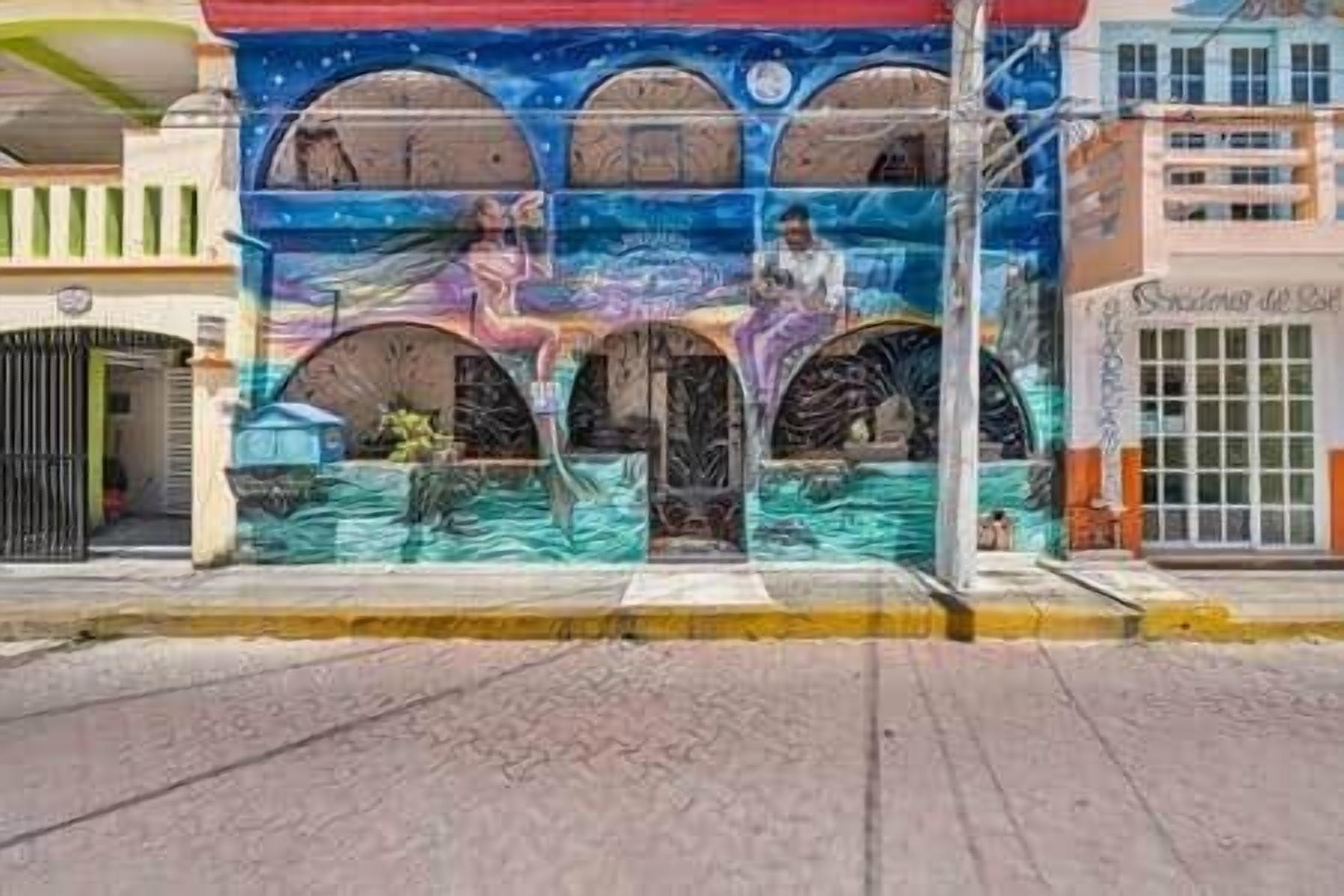 A building with a mural featuring arches and a central figure.