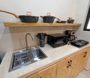 Fridge, microwave, coffee/tea maker, cookware/dishes/utensils