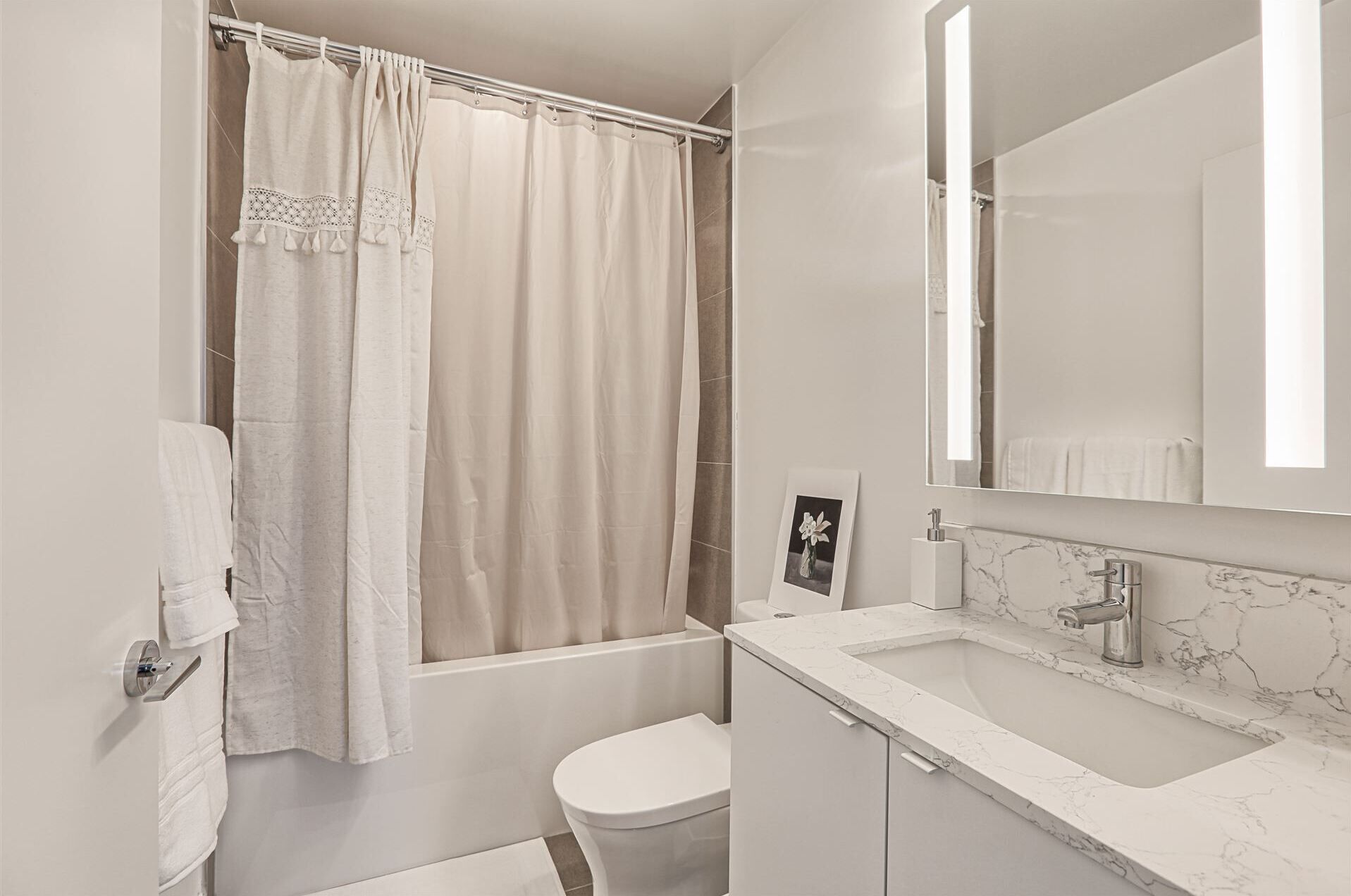 Une salle de bain moderne avec une baignoire, des toilettes et un lavabo en marbre.