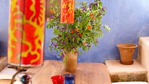 A wooden table with a vase of flowers, hanging lanterns, and small decorative cups. - Thedreamhouse Chlorinefree Heated Pool Artvillage (Rhodes)