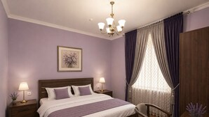A bedroom with a bed, two bedside tables, a chair, a desk, a chandelier, and a window with curtains. - Silk Nest Hotel (Bukhara)