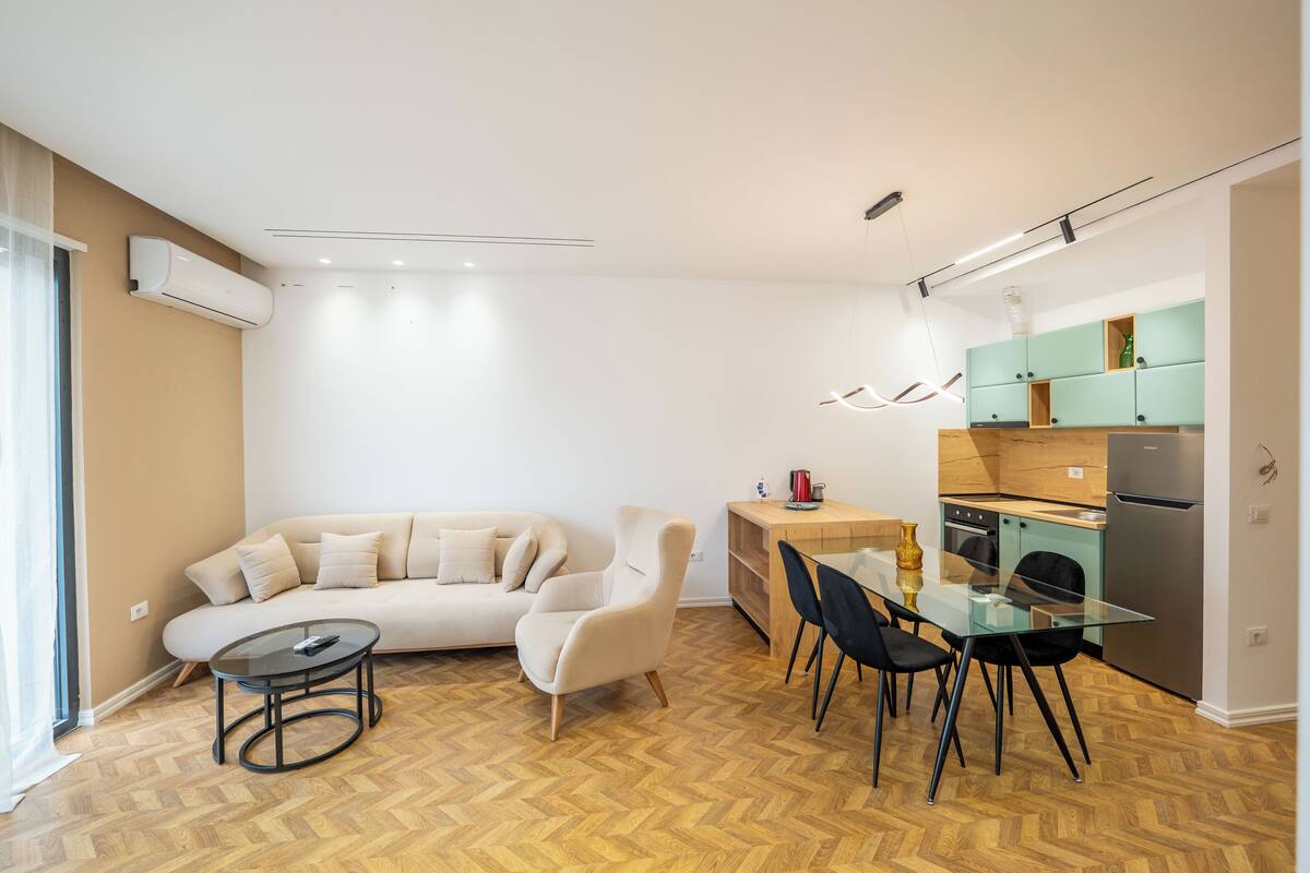 A modern apartment with a living area, dining space, and kitchen.