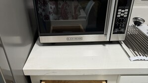 A kitchen drawer with a set of silverware and a knife.