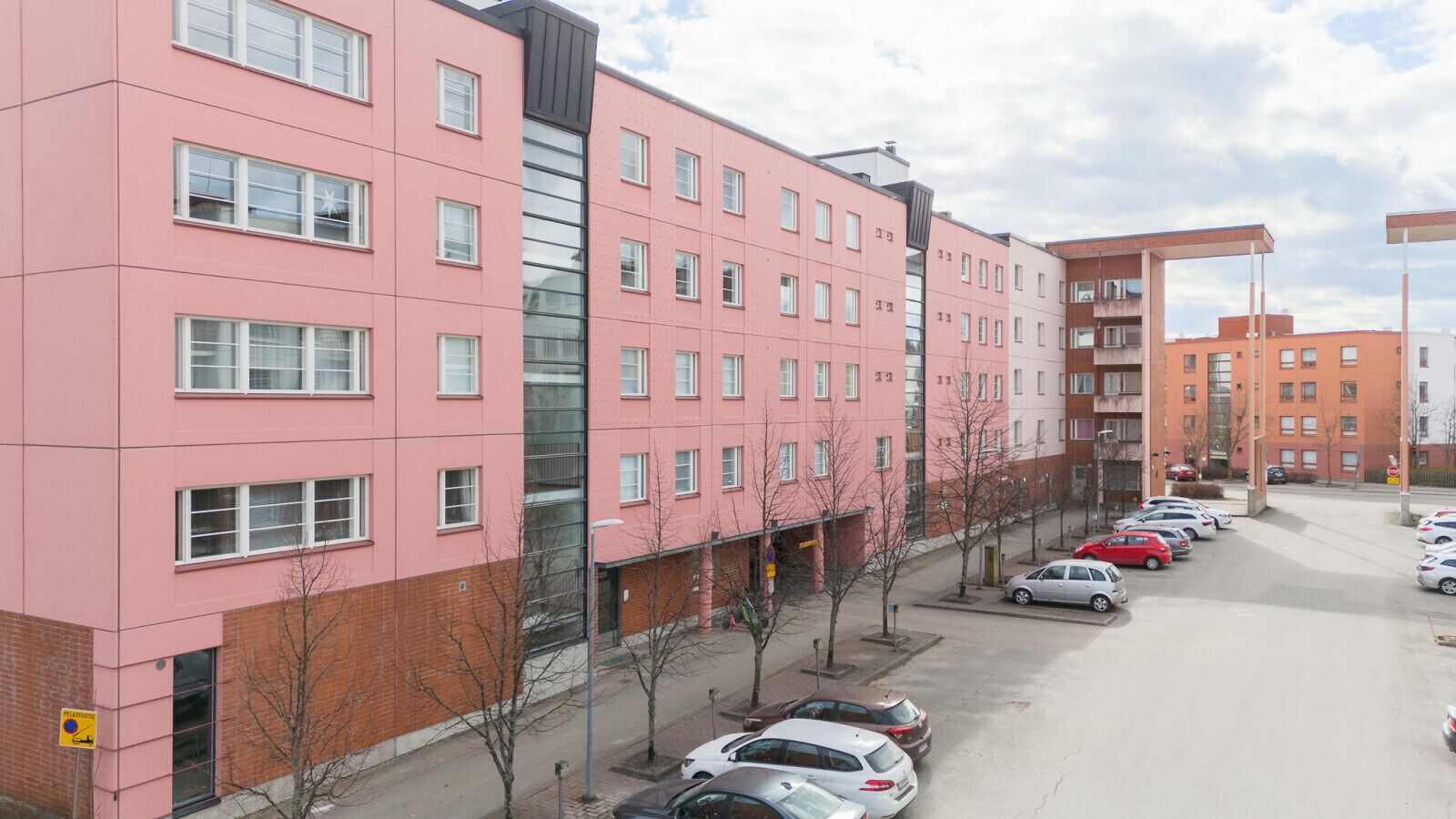 A multi-story parking garage with several cars parked.