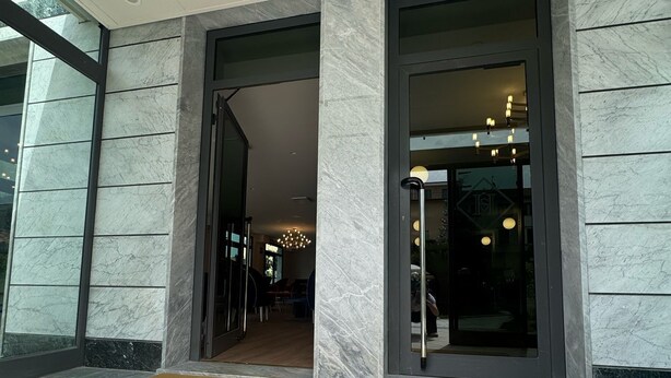 A hotel entrance with a marble facade, a doormat with the hotel's name, and a glass door leading inside. - Hotel Harmony&Smile (Lido di Camaiore)