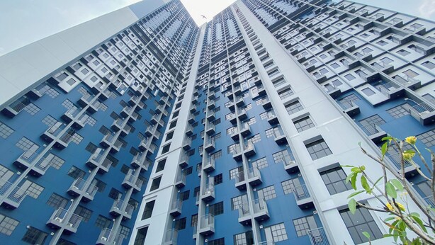 A high-rise building with multiple balconies and windows.