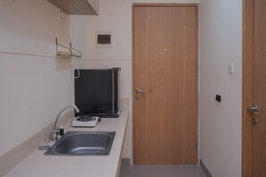 Standard Apartment | Private kitchen - Convenient Studio Apartment At B Residence (Pagedangan)