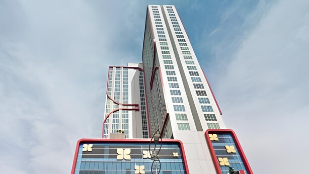 A modern high-rise building with a prominent vertical design, featuring large windows and a mix of red and white colors. - Best Price And Relaxing Studio (No Kitchen) At Tamansari Papilio Apartment (Surabaya)