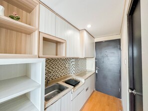 Standard Apartment | Private kitchen - Restful And Good Choice Studio At Tamansari Papilio Apartment (Surabaya)