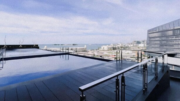 A rooftop terrace with a clear view of the sea and buildings in the distance. - The Good Estate Studio At Delft Ciputra Makassar Apartment (Makassar)