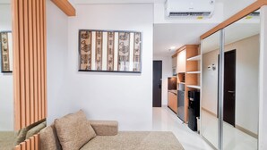 A modern living room with a sofa, a decorative wall piece, and built-in cabinetry.