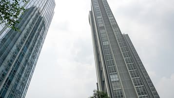 Two tall, modern skyscrapers with reflective glass facades, viewed from a low angle looking up.