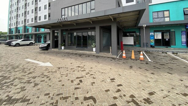 A modern building with a sign reading "ARAYA" on the facade. - Cozy And Homey Studio At Riverdale Apartment (Cikarang)