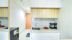 Standard Apartment | Private kitchen - Nice And Comfy Studio At Evenciio Margonda Apartment (Depok)