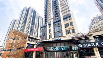 A commercial area with high-rise buildings, a bank, and various shops including a restaurant.