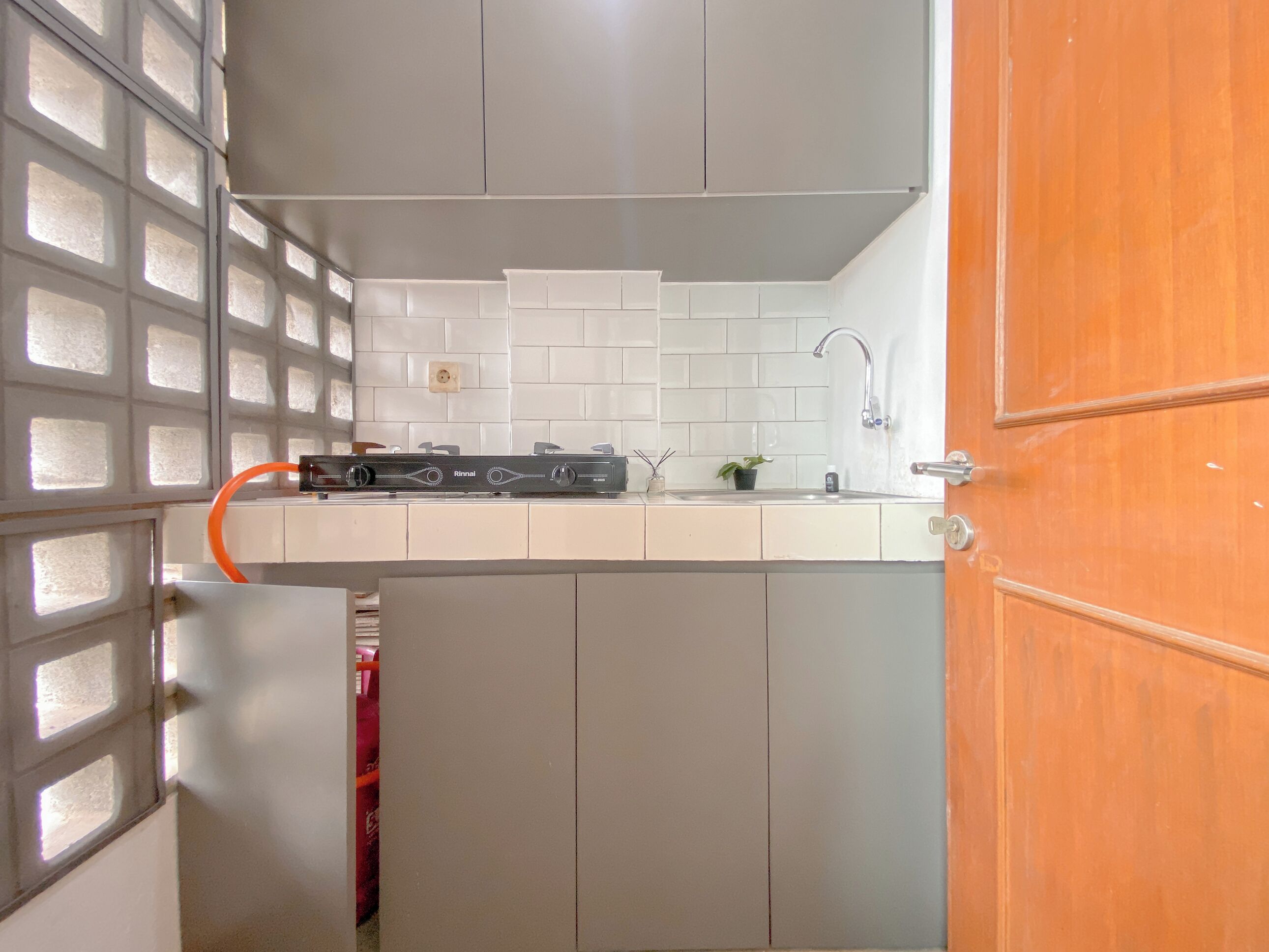 A kitchen with white cabinets, a gas stove, and a sink.