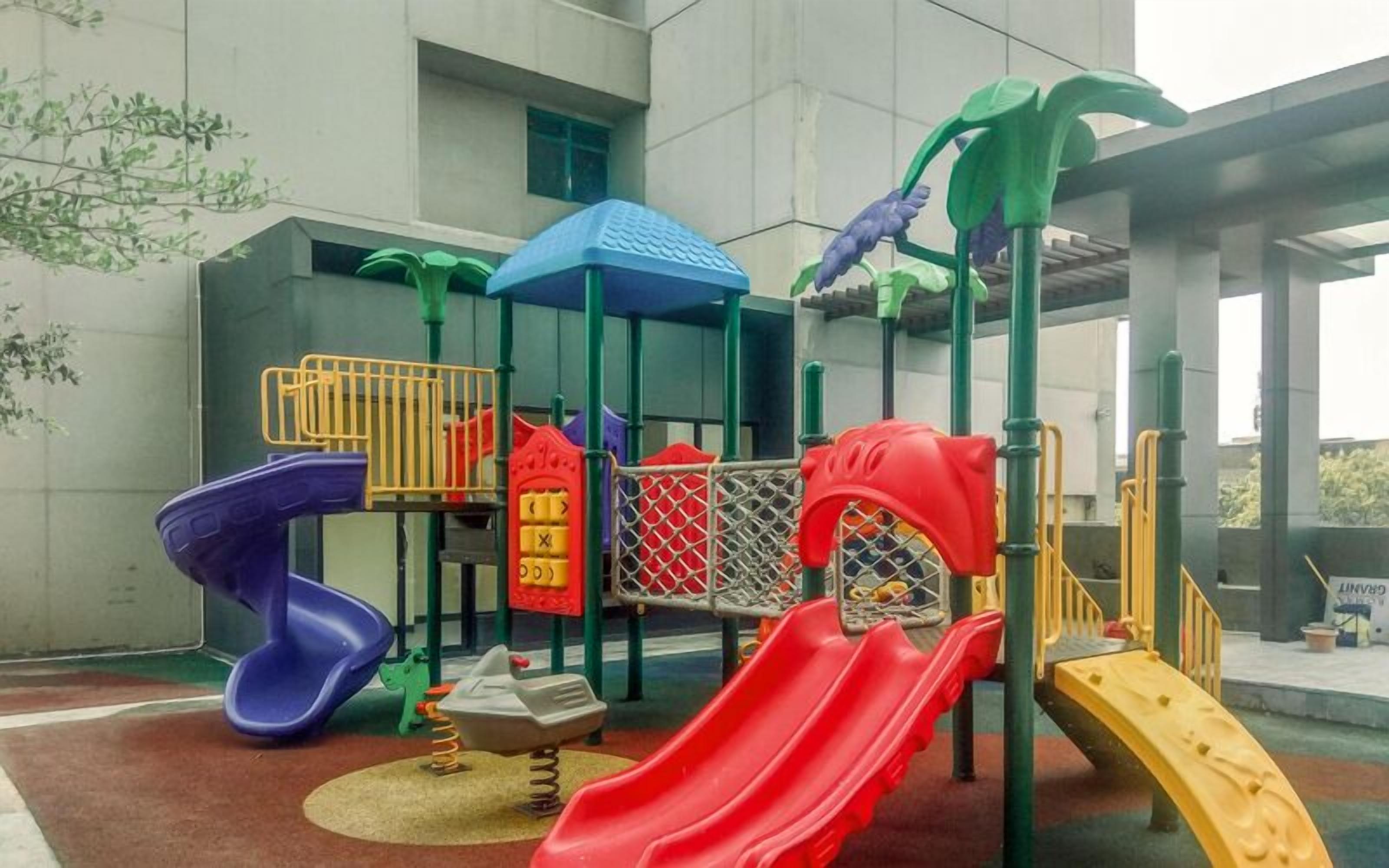 A playground with slides, swings, and climbing structures.