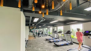 A gym with treadmills, weights, and exercise equipment.