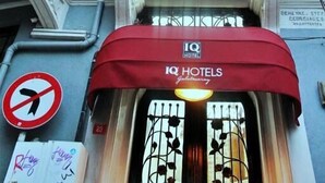 A hotel entrance with a red awning, a no right turn sign, and a sign for IQ Hotels. - IQ Hotel Galatasaray (Istanbul)