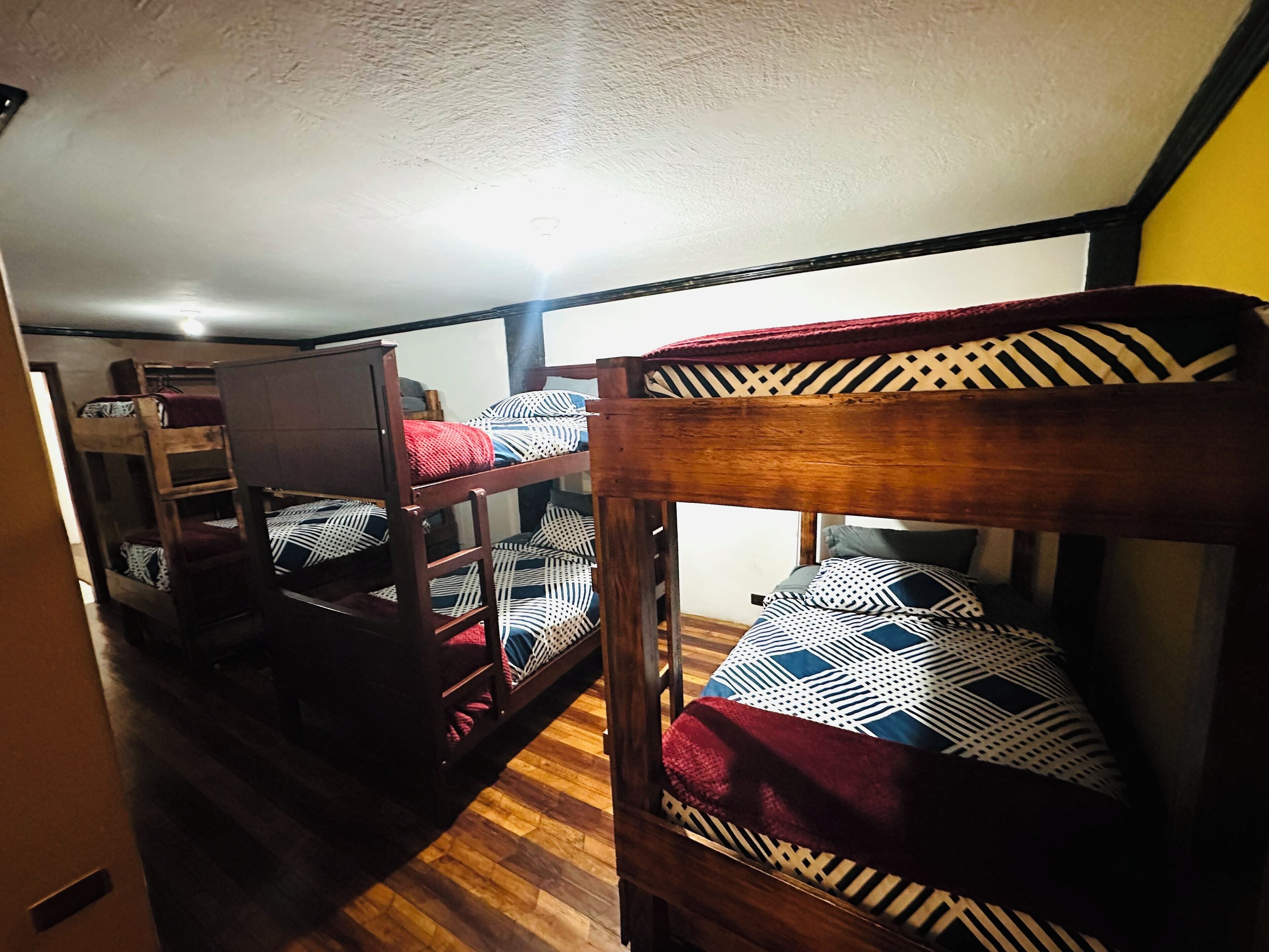 A bunk bed room with a wooden headboard and a ladder.